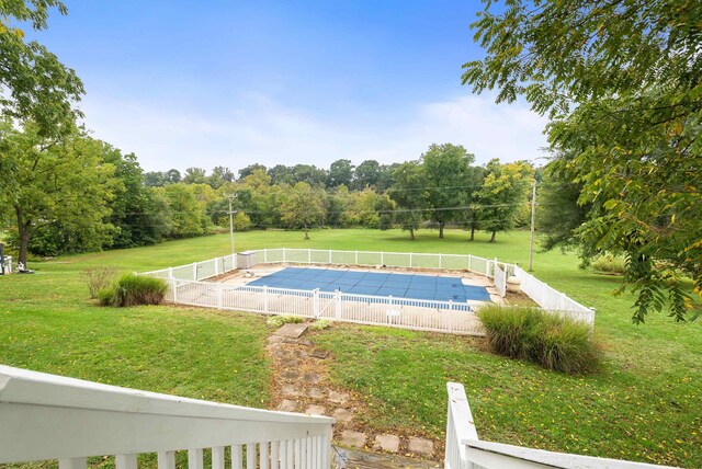 view of pool with a yard