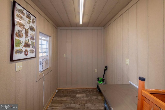 interior space with dark hardwood / wood-style flooring, cooling unit, and wood ceiling