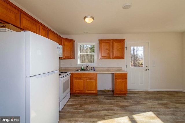 kitchen featuring dark hardwood / wood-style floors, sink, and white appliances