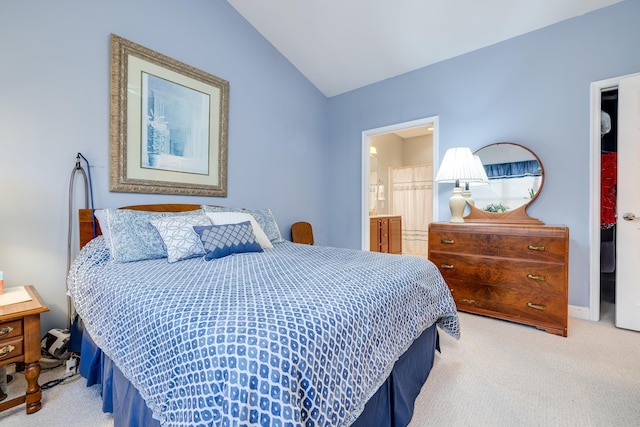 carpeted bedroom featuring ensuite bathroom and lofted ceiling