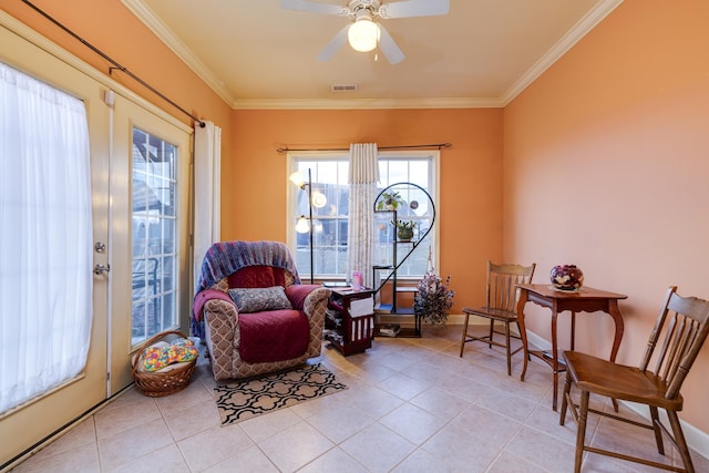 sitting room with light tile patterned floors, crown molding, and ceiling fan