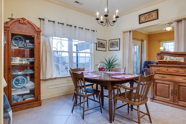 tiled dining room with ornamental molding and a chandelier