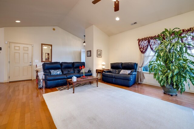 living room featuring ceiling fan, lofted ceiling, and hardwood / wood-style floors