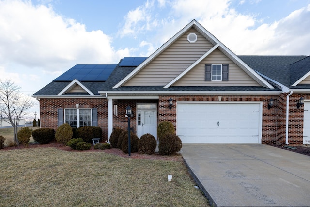 view of front of house featuring a garage, a front lawn, and solar panels