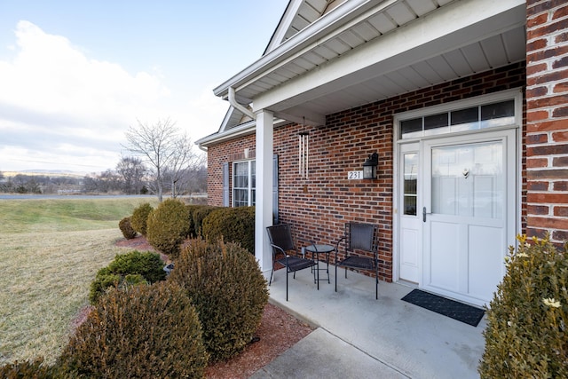 view of exterior entry with a lawn