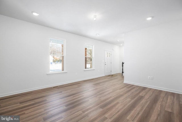 empty room featuring dark hardwood / wood-style flooring