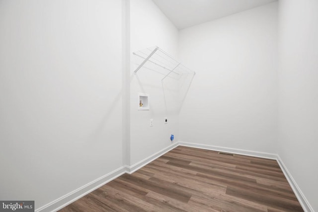 laundry room featuring hookup for a washing machine, hookup for an electric dryer, and dark hardwood / wood-style flooring