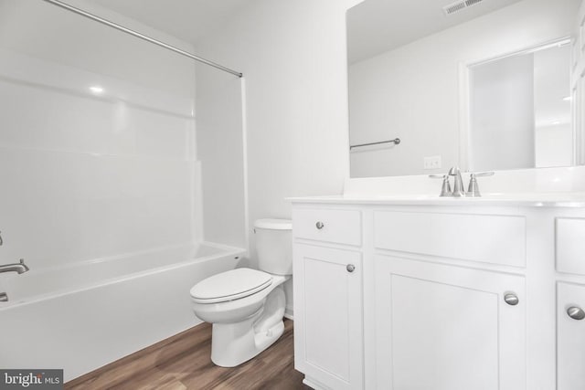 full bathroom featuring vanity, toilet, hardwood / wood-style floors, and shower / bathing tub combination