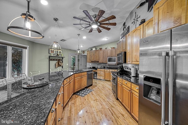 kitchen featuring visible vents, a ceiling fan, decorative light fixtures, stainless steel appliances, and light wood-style floors