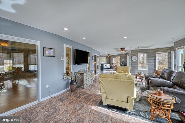 living area featuring ceiling fan, recessed lighting, and baseboards