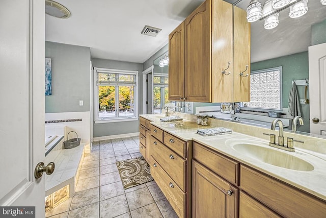 interior space featuring visible vents, light countertops, a sink, and light tile patterned flooring