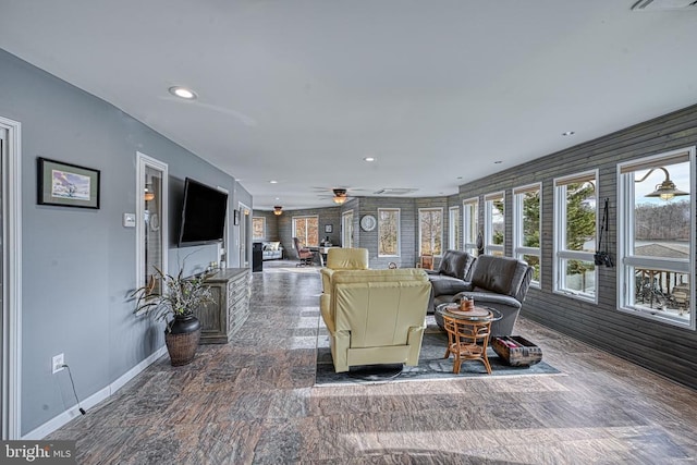 living room featuring a ceiling fan, recessed lighting, and baseboards