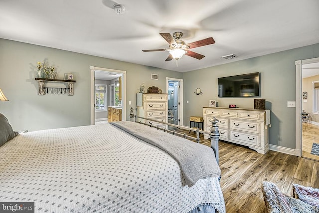 bedroom with visible vents, ceiling fan, baseboards, and wood finished floors