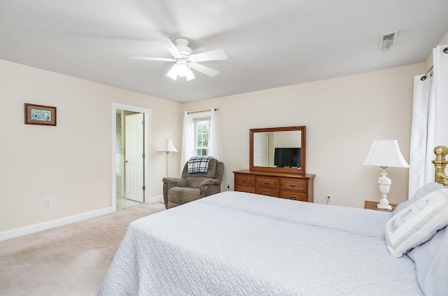 bedroom featuring baseboards, ceiling fan, visible vents, and light carpet