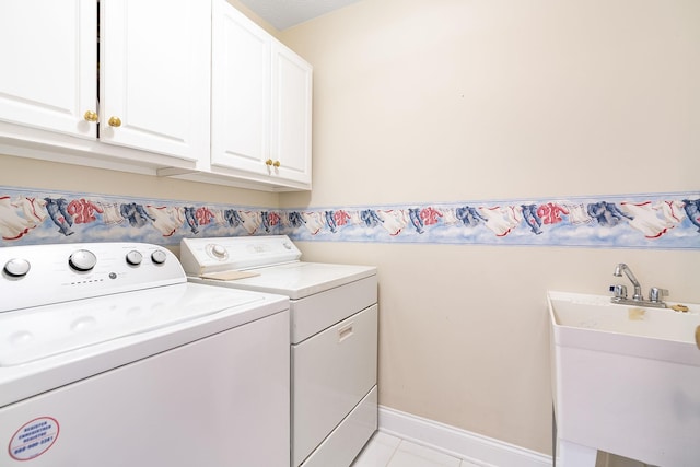 laundry room with cabinet space, a sink, baseboards, light tile patterned flooring, and washer and dryer