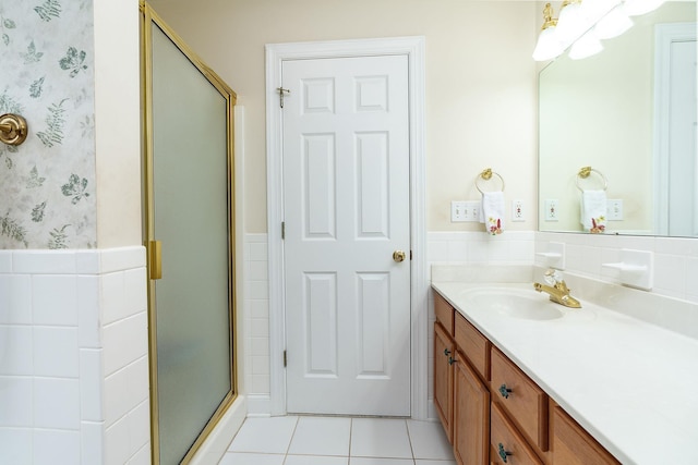 bathroom with tile patterned flooring, wainscoting, a stall shower, vanity, and wallpapered walls
