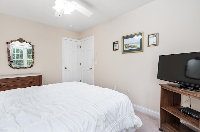 carpeted bedroom with baseboards and ceiling fan