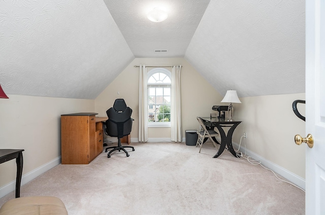 carpeted home office featuring baseboards, visible vents, a textured ceiling, and lofted ceiling
