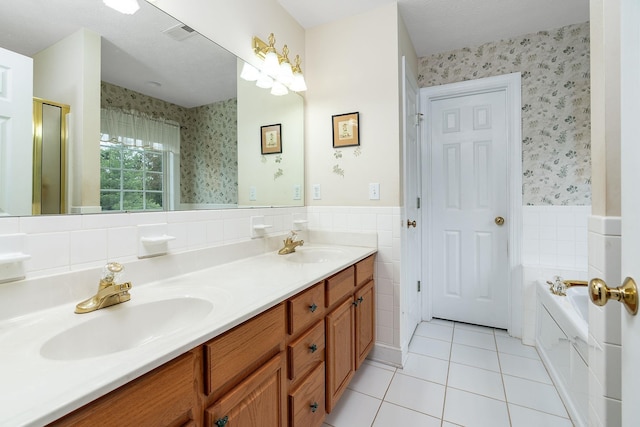full bath with a sink, wainscoting, tile patterned floors, and wallpapered walls