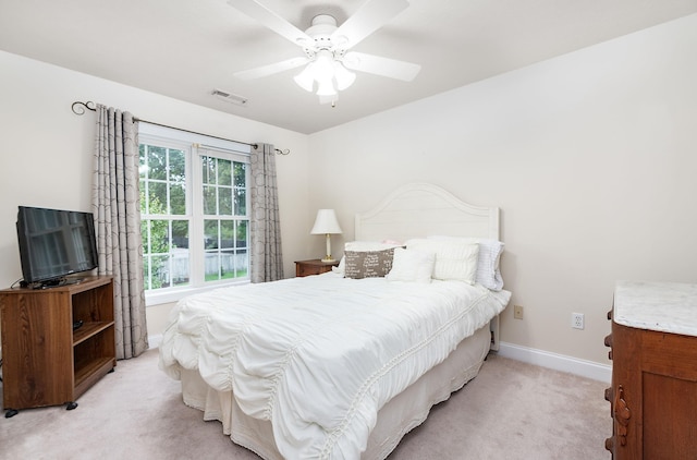 bedroom with a ceiling fan, baseboards, light colored carpet, and visible vents