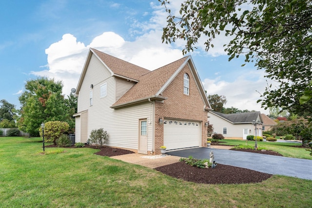 view of home's exterior with driveway, roof with shingles, a lawn, a garage, and brick siding
