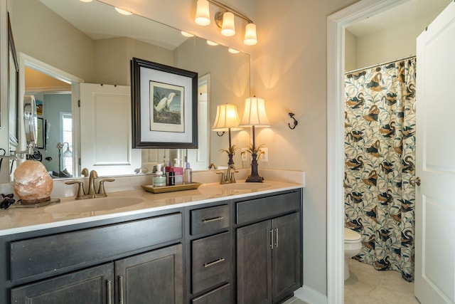full bath featuring tile patterned flooring, a sink, double vanity, and toilet