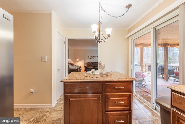 kitchen featuring ornamental molding, a notable chandelier, hanging light fixtures, and light stone counters