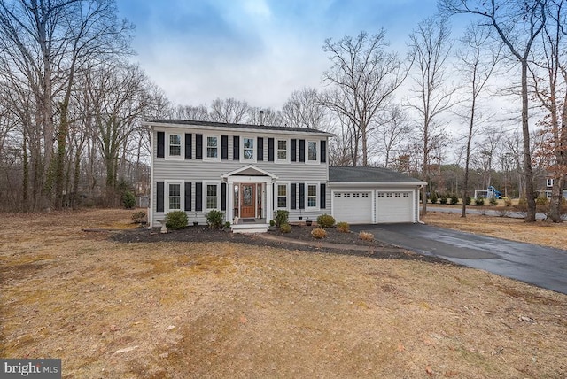 view of front of property featuring a garage and aphalt driveway