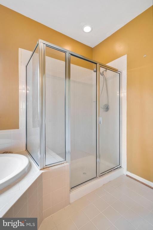 bathroom featuring separate shower and tub