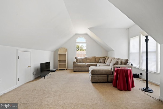 carpeted living room with vaulted ceiling