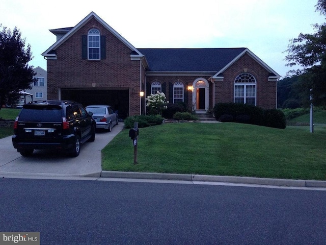 front facade with a garage and a front yard