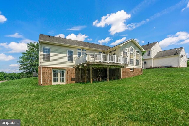 back of house with a yard and a deck