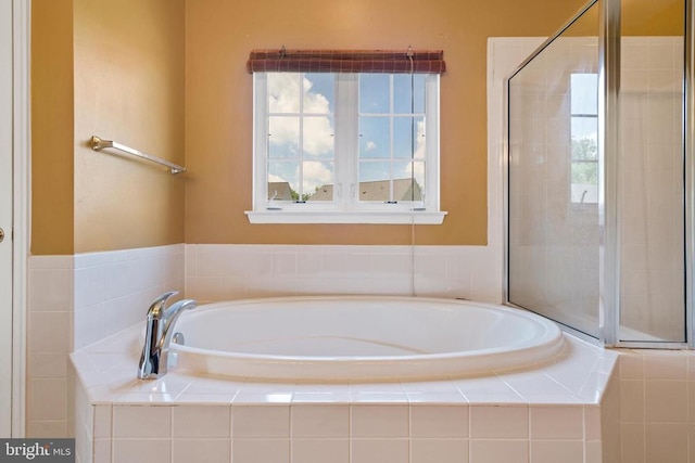 bathroom featuring separate shower and tub