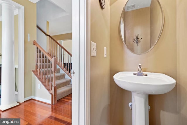 bathroom featuring wood-type flooring and decorative columns