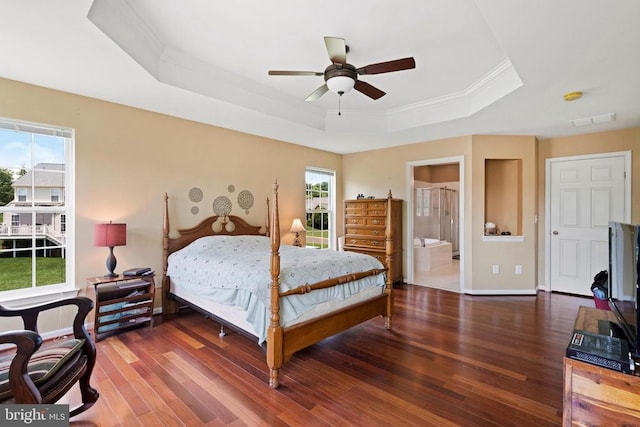 bedroom with ornamental molding, ceiling fan, dark hardwood / wood-style flooring, and a tray ceiling