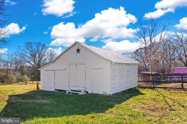 view of outdoor structure with a lawn