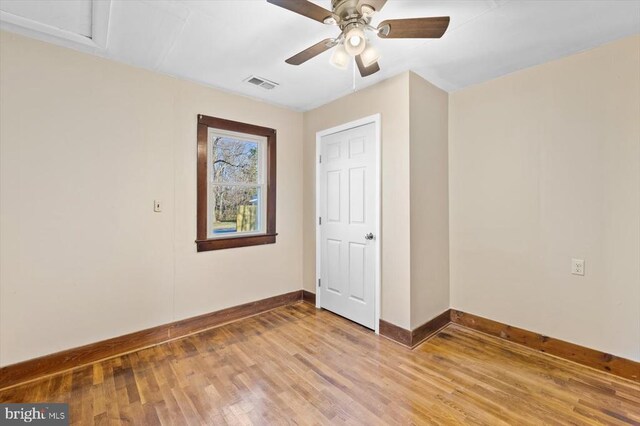 unfurnished bedroom with ceiling fan and light wood-type flooring