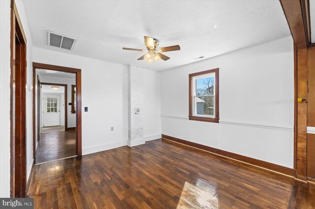 spare room featuring dark hardwood / wood-style floors and ceiling fan