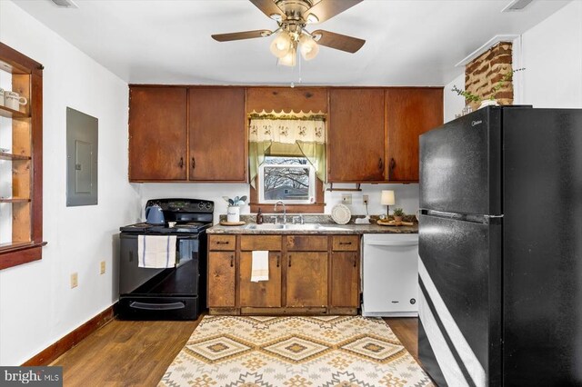 kitchen with sink, dark wood-type flooring, ceiling fan, electric panel, and black appliances