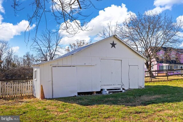 view of outbuilding with a yard