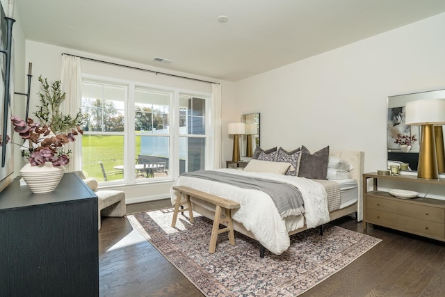 bedroom with dark hardwood / wood-style floors