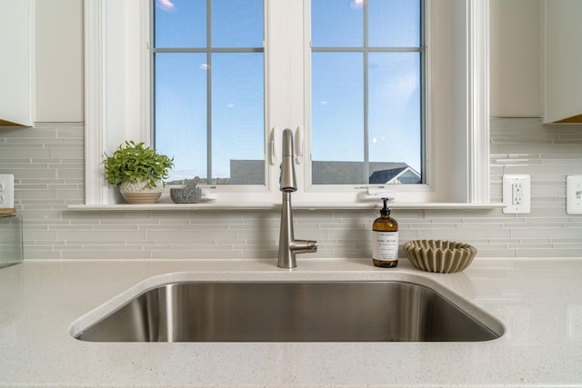 room details featuring sink and decorative backsplash