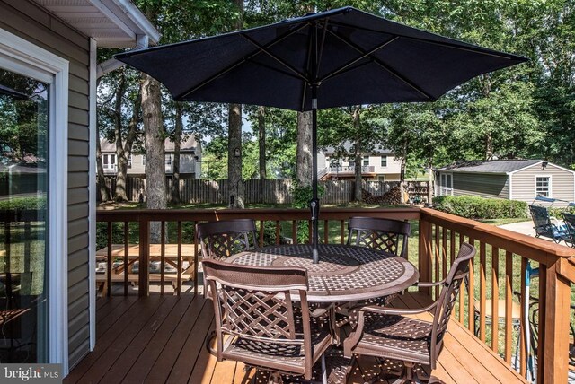 single story home featuring aphalt driveway, an attached garage, a porch, and a front yard