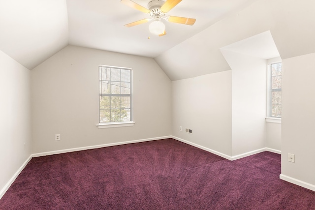 bonus room with vaulted ceiling, carpet floors, a wealth of natural light, and ceiling fan