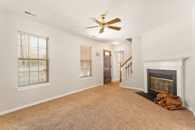 living room with ceiling fan and carpet flooring