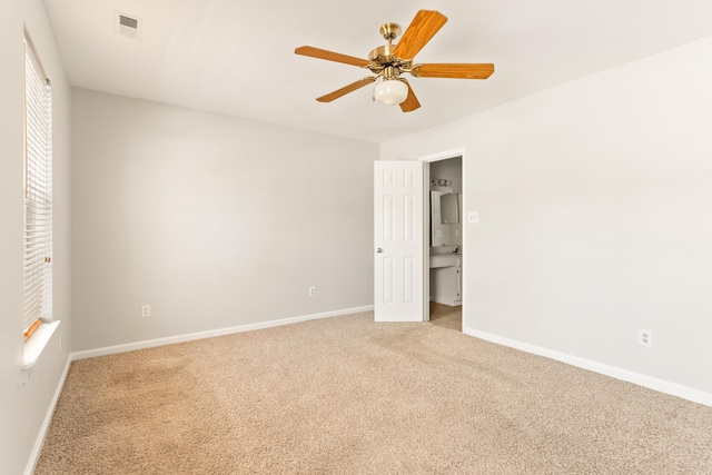 unfurnished bedroom featuring ceiling fan and light colored carpet