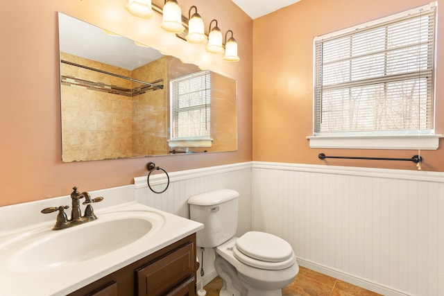 bathroom featuring vanity, tile patterned flooring, and toilet