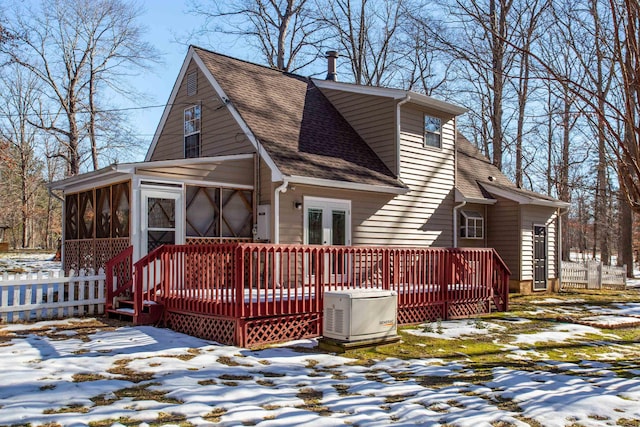 exterior space featuring a wooden deck and a sunroom