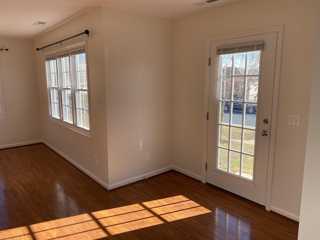 entryway featuring visible vents, baseboards, a healthy amount of sunlight, and wood finished floors