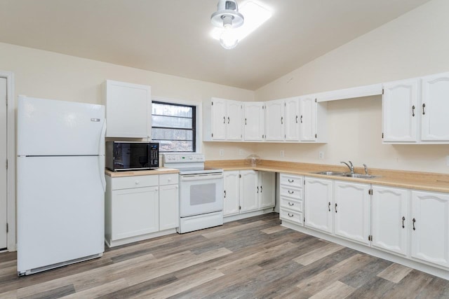 kitchen featuring vaulted ceiling, white appliances, sink, and white cabinets